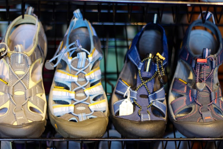 A row of colorful Keen sandals